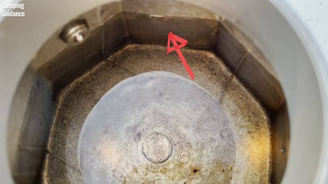 Here's a marked line on the Bialetti Moka Express showing you the maximum water level below the safety valve.