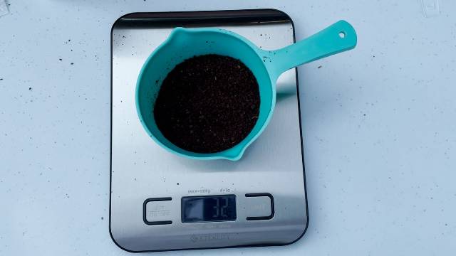 Using an Etekcity Digital Kitchen Scale to measure out coffee grounds (32 grams for 3 cups of coffee).
