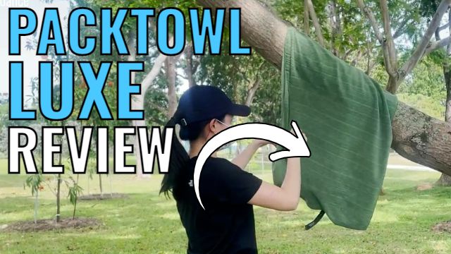 This is a picture of me hanging the PackTowl Luxe towel on a tree branch.