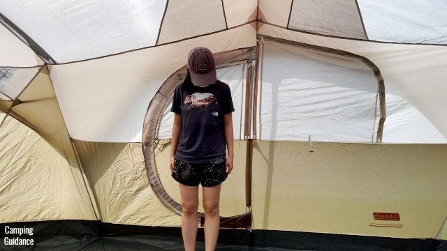 This is a picture of me standing in front of the hinged D-door of the Coleman WeatherMaster 10-Person Tent.