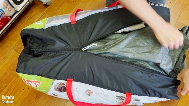 This is a picture of me trying to stuff everything back into the carry bag of the Coleman WeatherMaster 10-Person Tent.