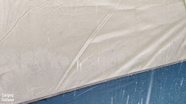 This is a close-up of the picture right above. This is one of the Ozark Trail 10-Person Cabin Tent's window mesh. Notice that even in light rain, quite a bit of the window mesh is already getting damp.