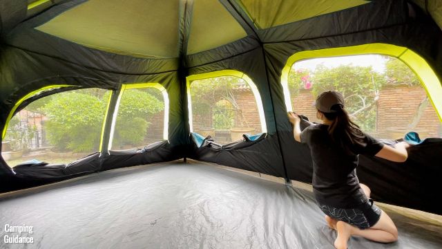 In this picture, you can see the different sized windows of the Coleman 10-Person Instant Cabin Tent, and that’s me in the picture opening up all the windows. (From left to right: mesh of hinged door, window beside hinged door, biggest window, and second biggest window).