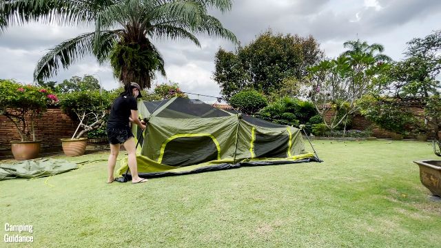 This is a picture of me setting up the Outdoor Products 10-Person Instant Cabin tent on my own.