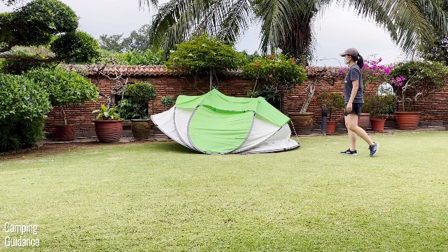 This is another picture of the Coleman 4-Person Pop Up Tent popping up, 1-2 seconds later.