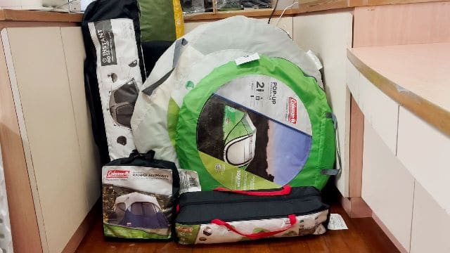 My collection of 14 Coleman tents in my room.