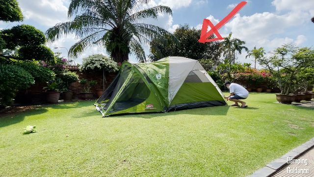 This is a picture of my brother and I setting up the rainfly of the Coleman Evanston 6-Person Tent. The red arrow is pointing to where the rainfly pole is.