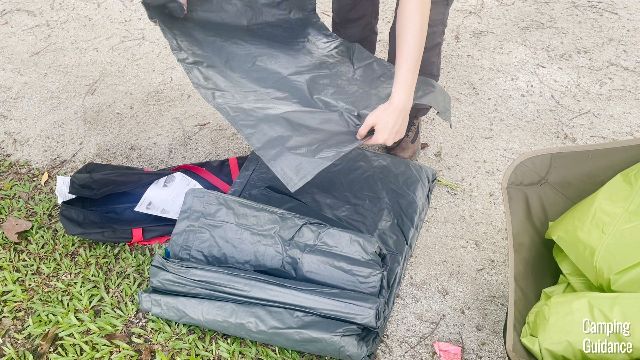 From left to right: In this picture, you can see the carry bag (black), tent body and foot mat (gray), and the rainfly (green) of the Coleman Carlsbad Tent.