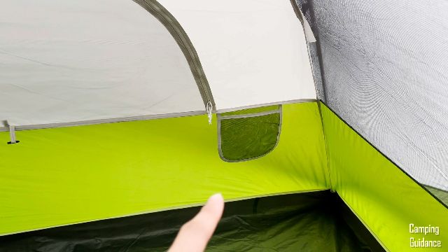 This is a picture of me pointing to one of the pockets inside the Coleman Evanston 6-Person Tent.
