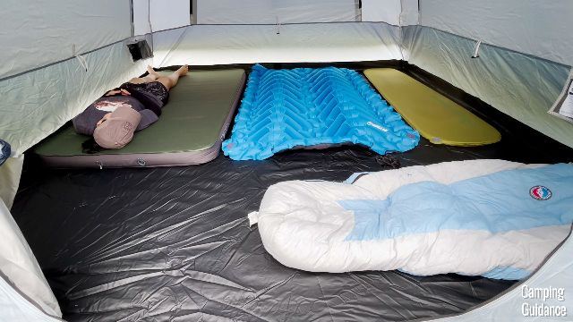 This is what 6 pads looks like inside the Caddis Rapid 6. From left to right: Exped MegaMat Duo 10 (green), Klymit Double V Uninsulated (blue), Sea to Summit pad (yellow), Big Agnes sleeping bag (white). That's me lying on the Exped.