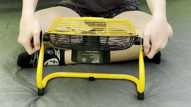 The author rotating the face of the Geek Aire Portable Camping Fan.