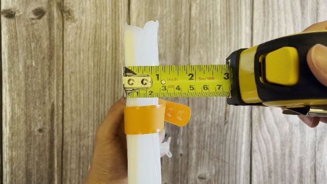 The author measuring the packed size of the LuminAID PackLite Max.