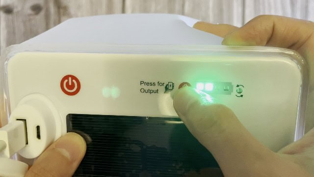 The press for output button on the LuminAID PackLite Max.