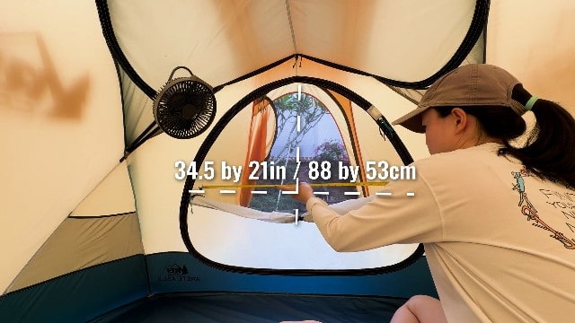 The author measuring the size of the REI Arete ASL 2's window.