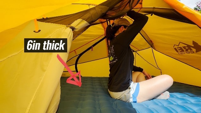 The author sitting under the peak height of the REI Trail Hut 2.
